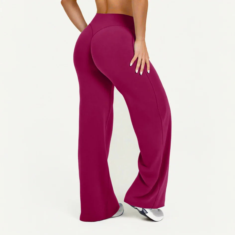 A model wearing high-waist magenta yoga pants from the side.