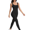 A woman models a black ribbed nylon bodycon jumpsuit for summer.