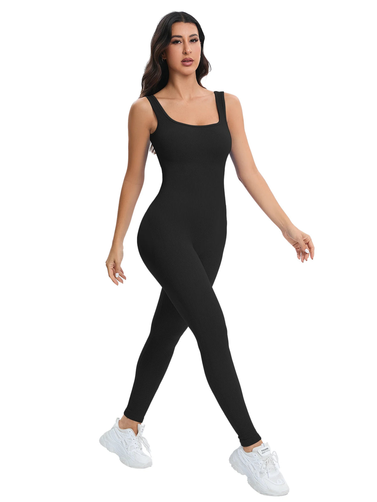 A woman models a black ribbed nylon bodycon jumpsuit for summer.