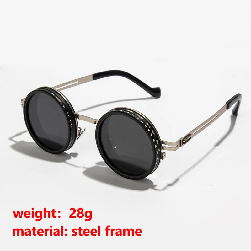A pair of black round sunglasses with a silver metal frame and adjustable arm.