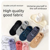 A collection of soft, durable yoga socks in various colors and patterns are displayed on a white background.