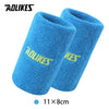 A pair of bright blue, fuzzy sport wristbands for activewear.