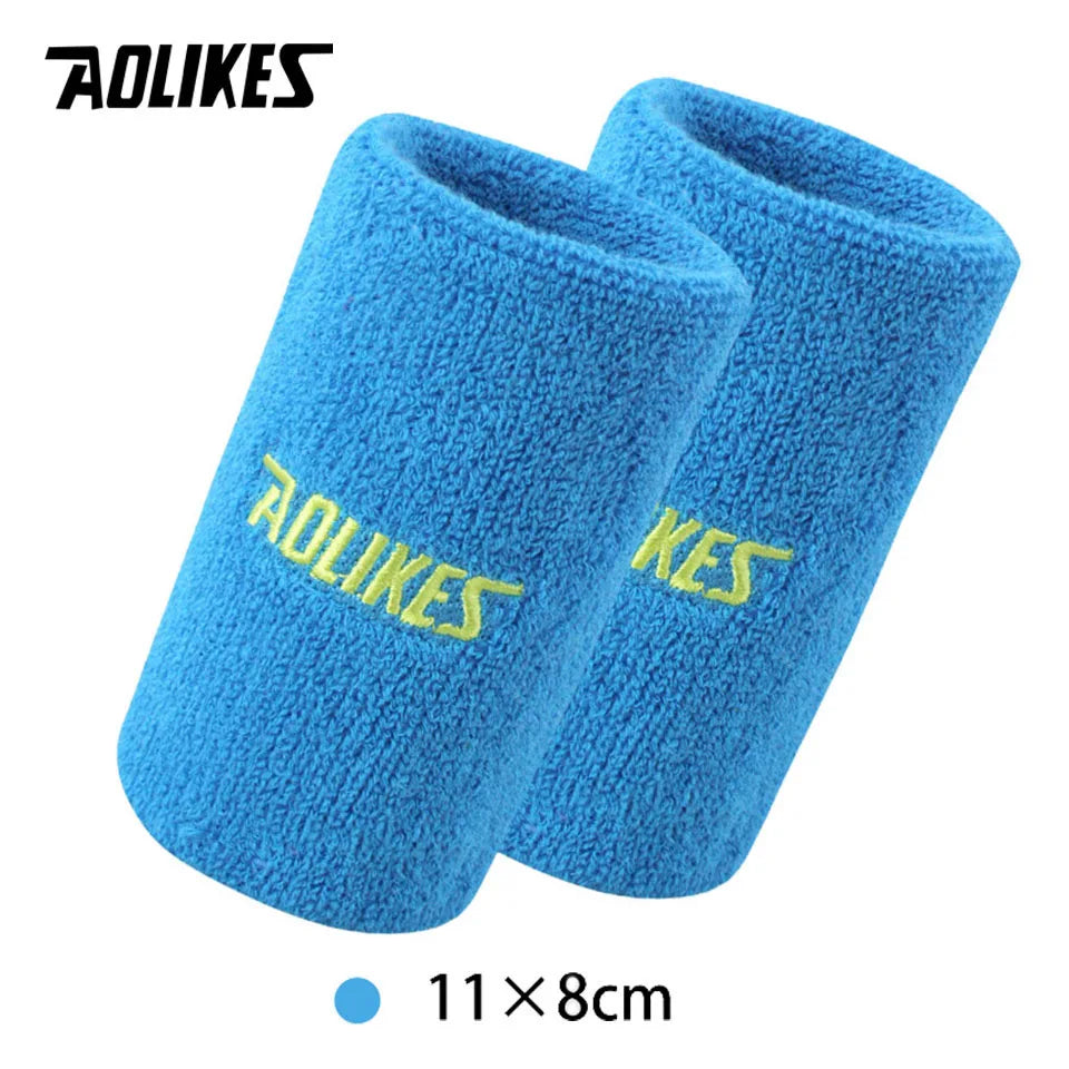 A pair of bright blue, fuzzy sport wristbands for activewear.