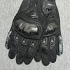 Black genuine leather motorcycle motocross gloves shown on a gray background.