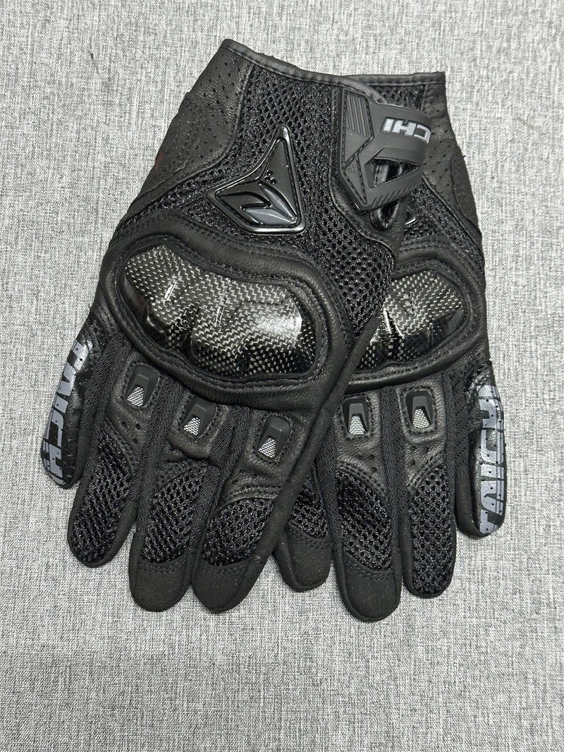 Black genuine leather motorcycle motocross gloves shown on a gray background.