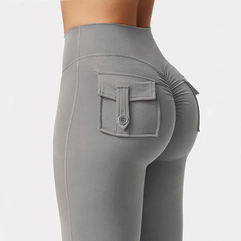 A close-up of a gray high stretch women's yoga legging featuring a front pocket detail.