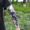 Close-up of a person wearing a long sleeve featuring a black and white tiger tattoo design.