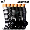 Six pairs of black and white compression socks displayed side by side.