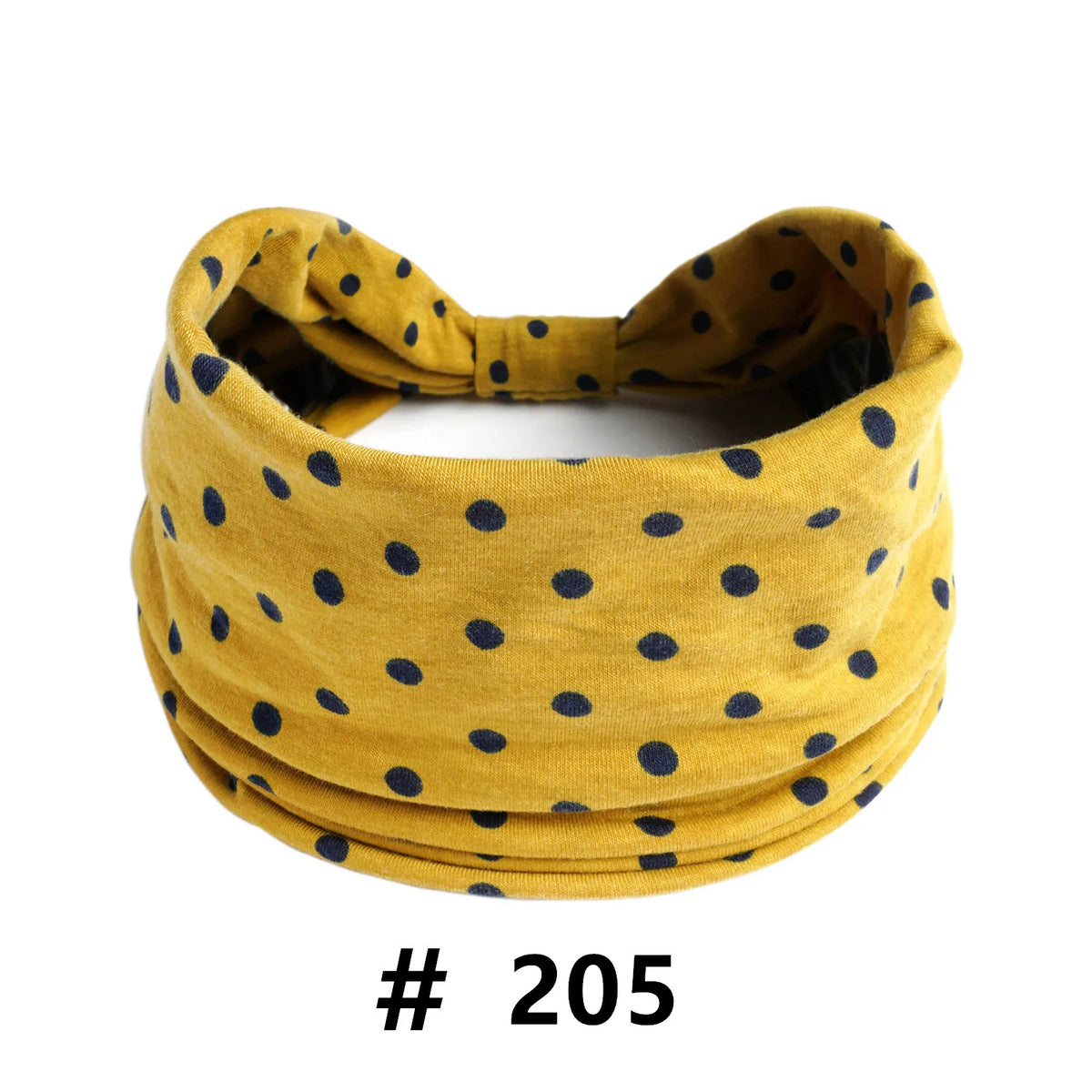 A mustard yellow knitted headband with small navy blue polka dots.