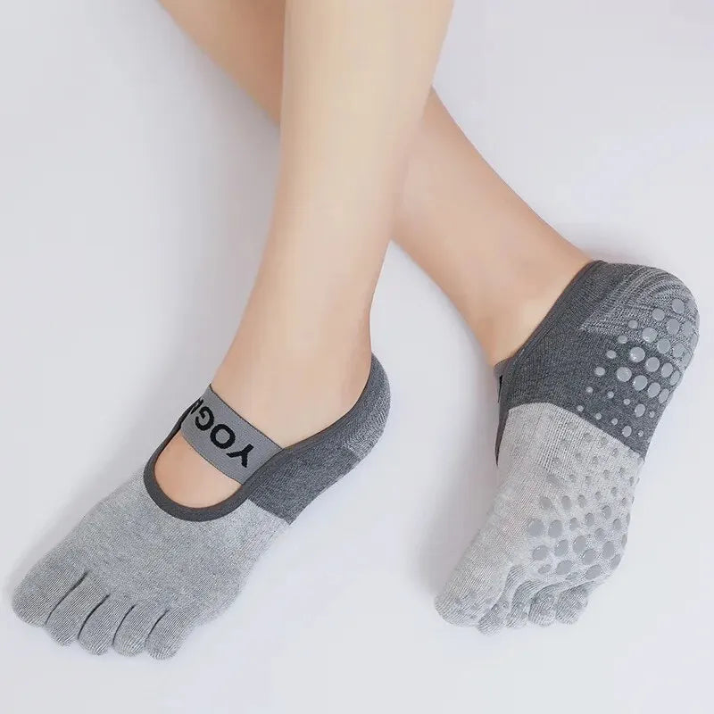 Gray silicone yoga and fitness socks worn on a foot