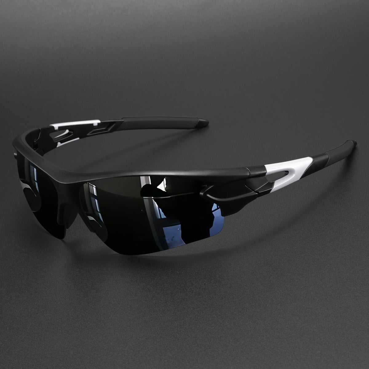 Black wraparound sports sunglasses with white accents resting on a dark surface.