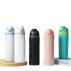 A set of white and black insulated stainless steel water bottles with dual drinking spouts.