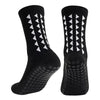 A pair of black multi-sport athletic grip socks shown from the side.