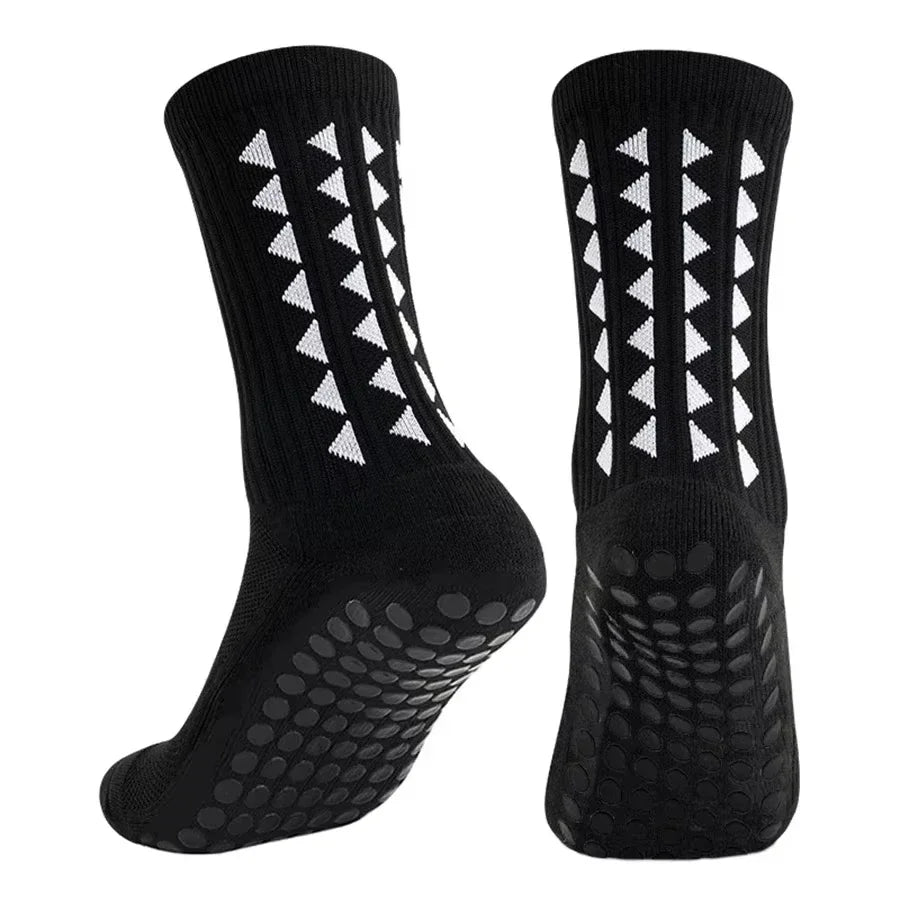 A pair of black multi-sport athletic grip socks shown from the side.