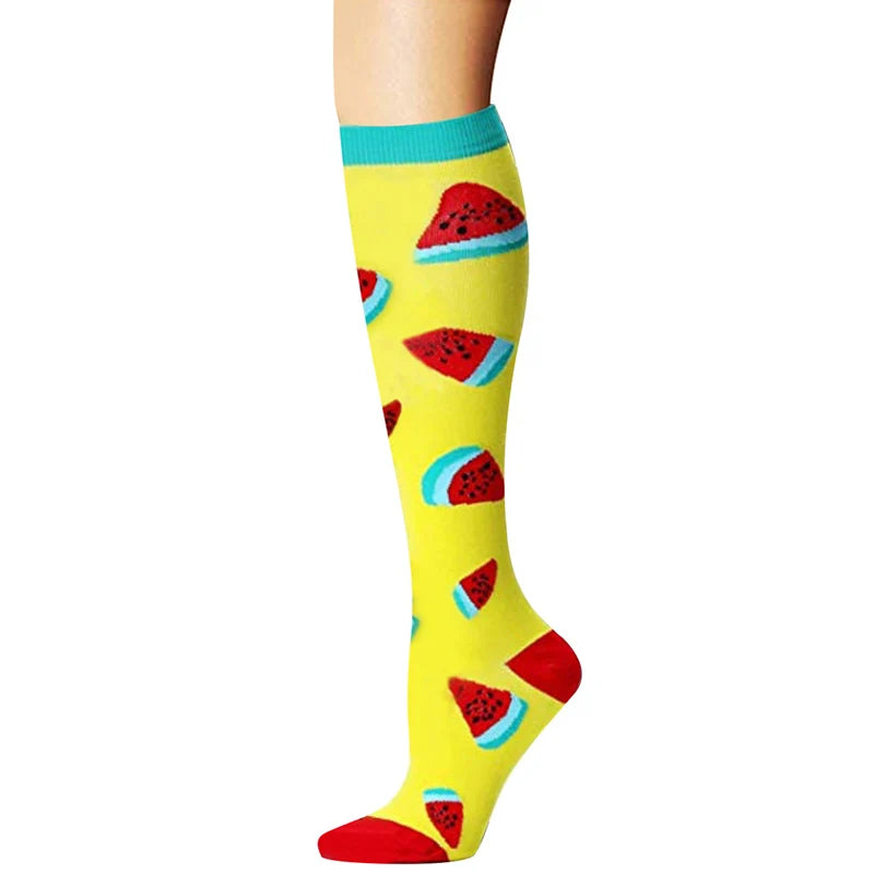 Yellow compression socks with red watermelon designs and teal cuffs