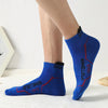 A close-up of a pair of royal blue men's athletic socks with red stitching and the Sportsman logo