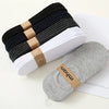 A stack of multi-colored breathable cotton ankle socks, including black, gray, and white pairs.