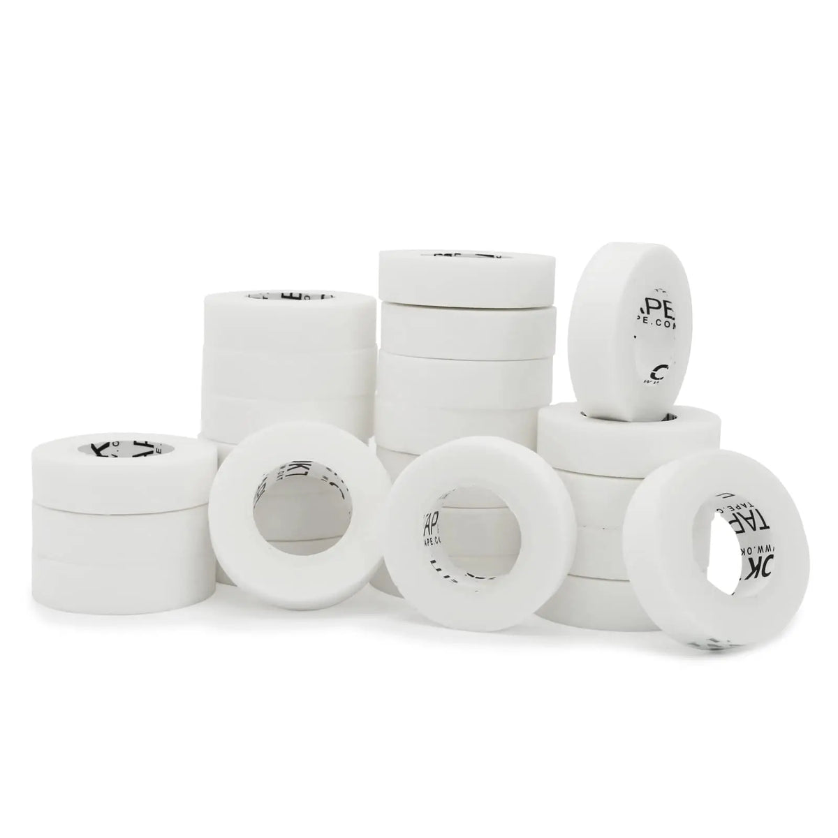 A collection of white latex-free nonwoven breathable medical tape rolls arranged in a row.