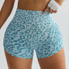 A model wears leopard print high-waist seamless shorts and a white cropped top.