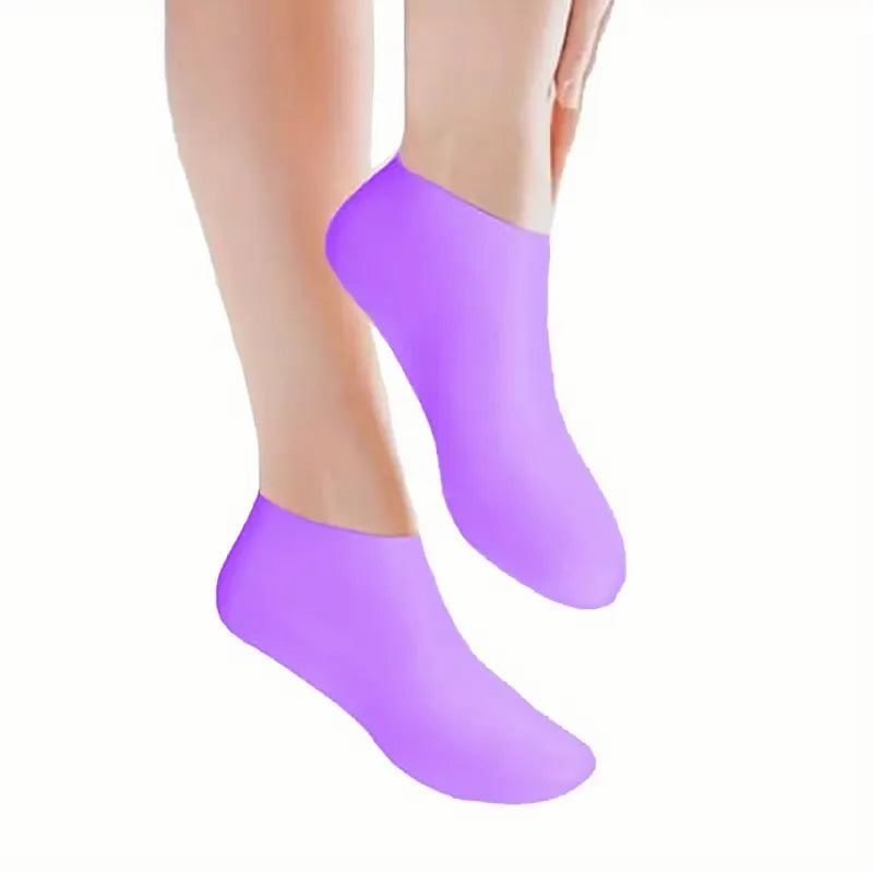 Purple silicone moisturizing socks worn on a foot.