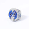 A close-up of a pair of championship rings featuring blue enamel and pave diamonds.