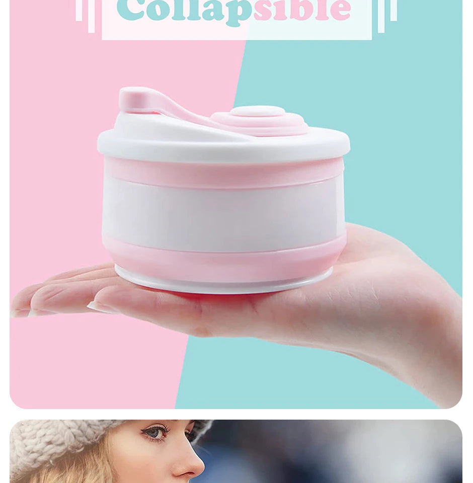 A hand holds a pink and white silicone collapsible coffee cup with a lid against a light background.