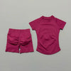A magenta seamless yoga set for women featuring a short sleeve top and matching workout leggings.