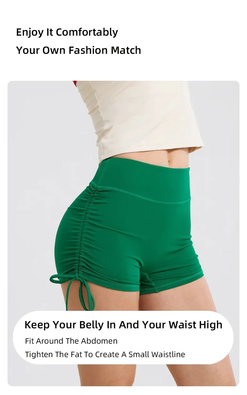 A person is wearing bright green performance yoga shorts, highlighting a small waistline.