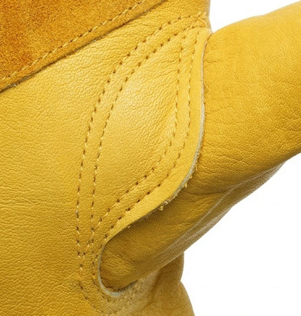Close-up of a yellow heavy duty cowhide leather work glove showing stitching and texture.