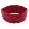 A red leopard print women's sports headband shown flat.