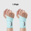 A pair of light blue wrist compression braces shown on a person's hands.