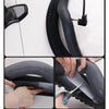 Hands are shown installing a bicycle puncture protection liner onto a tire.