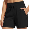 Black high-waisted quick-dry athletic shorts with a drawstring waist shown on a model.