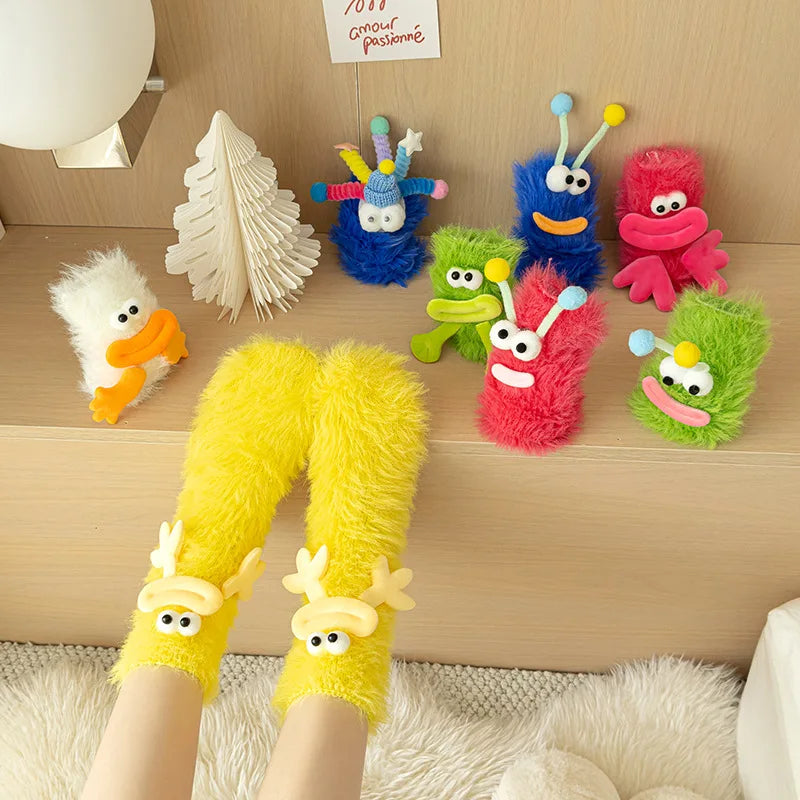 A set of colorful cartoon expression knit socks featuring characters like a blue monster, green creature, and pink animal.