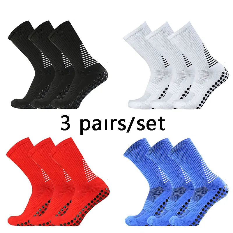 A set of 3 pairs of performance football socks in black, white, and blue colors.