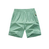 Light mint green men's lightweight quick-dry running shorts laid flat.