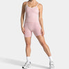 A woman models pink leopard print seamless yoga shorts and white socks.