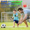 A young boy playing soccer with a goalie glove on a green field.