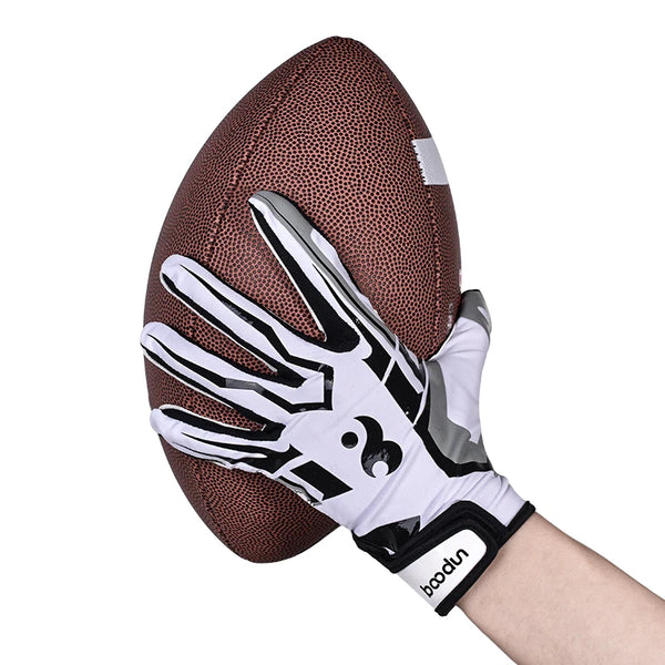 A hand wearing black and white anti-slip silicone sports gloves resting on a brown football.