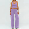 A woman wearing a purple women's premium fitness tracksuit top and matching pants.