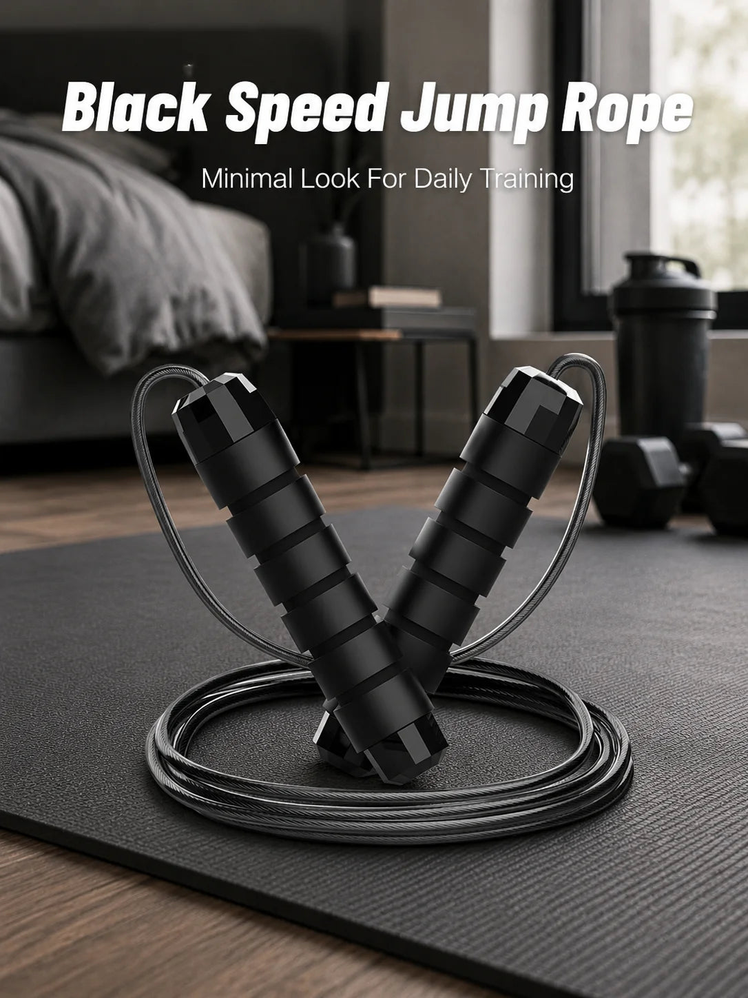 A pair of black speed jump ropes lying on a dark mat with a blurred background showing fitness equipment.