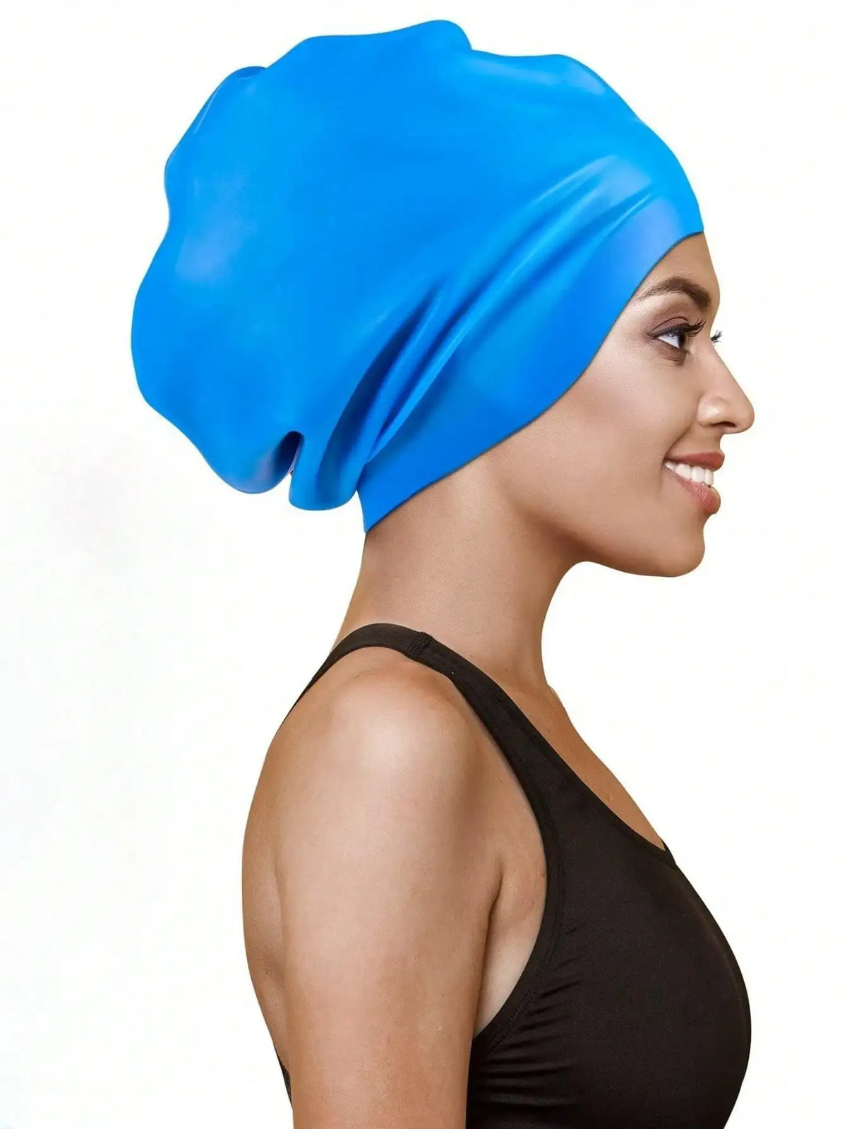 A woman wearing a bright blue silicone swim cap for long hair and braids.