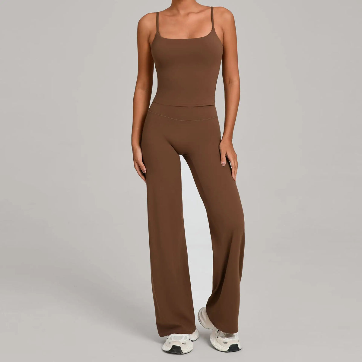 A woman wearing a brown high-waist yoga and fitness tracksuit set with matching top and pants.