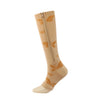 A beige compression sock with orange leaf patterns, shown standing upright.