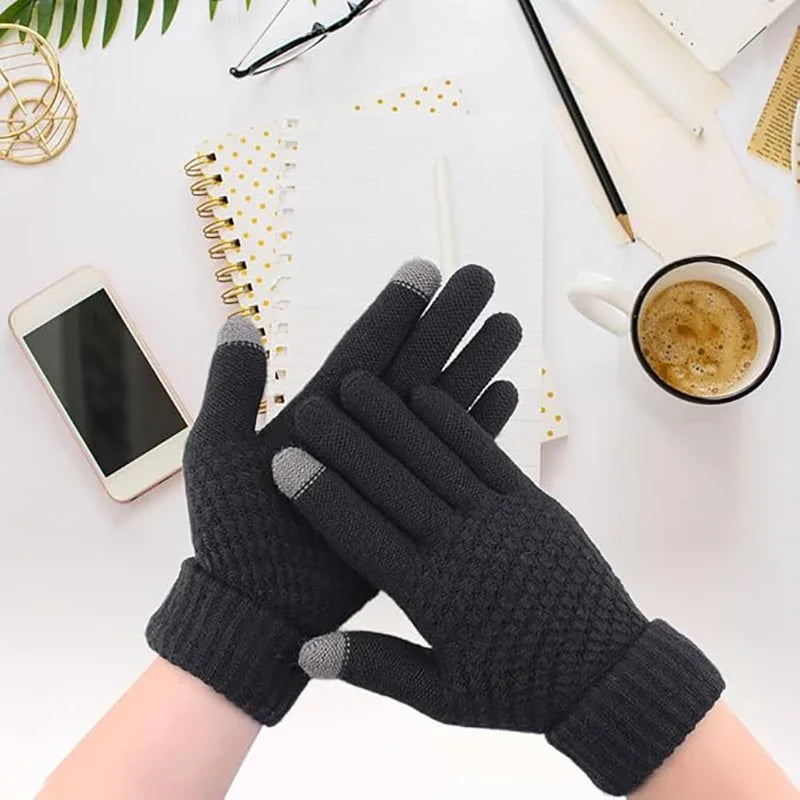A pair of black knitted insulated winter gloves with gray accents are shown against a white background.