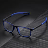 A pair of blue-framed reading glasses with a blue strap resting on a dark, textured surface.