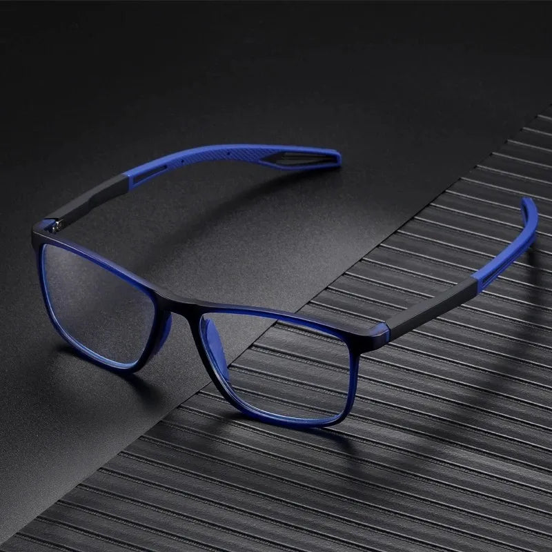 A pair of blue-framed reading glasses with a blue strap resting on a dark, textured surface.