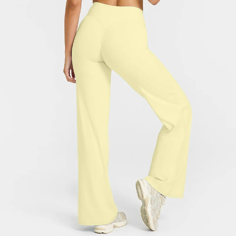 A light yellow pair of high-waist yoga pants shown from the side.