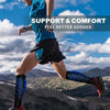A runner wearing blue compression socks is exercising outdoors with a scenic mountain background.