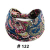 A close-up of a floral print cotton headband in blue, pink, and green fabric.